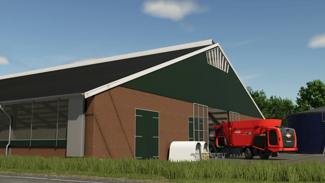 FS25 mod Cowshed 3+3 v1.1.0.0 showing a large barn with a red feeding machine outside.