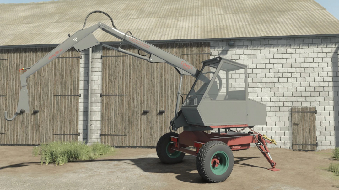 Cyklop T214 mod in FS25 next to a barn, showcasing its crane and wheels.