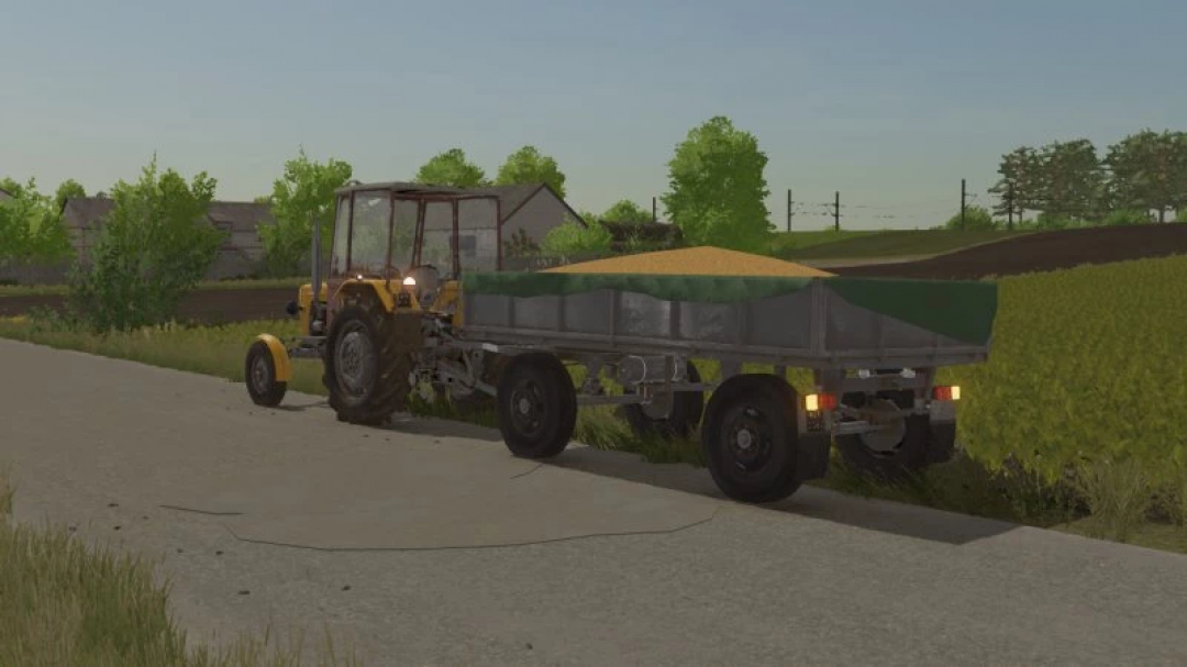 FS22 Ursus C330 mod in Farming Simulator 22 towing a trailer filled with grain on a rural road.