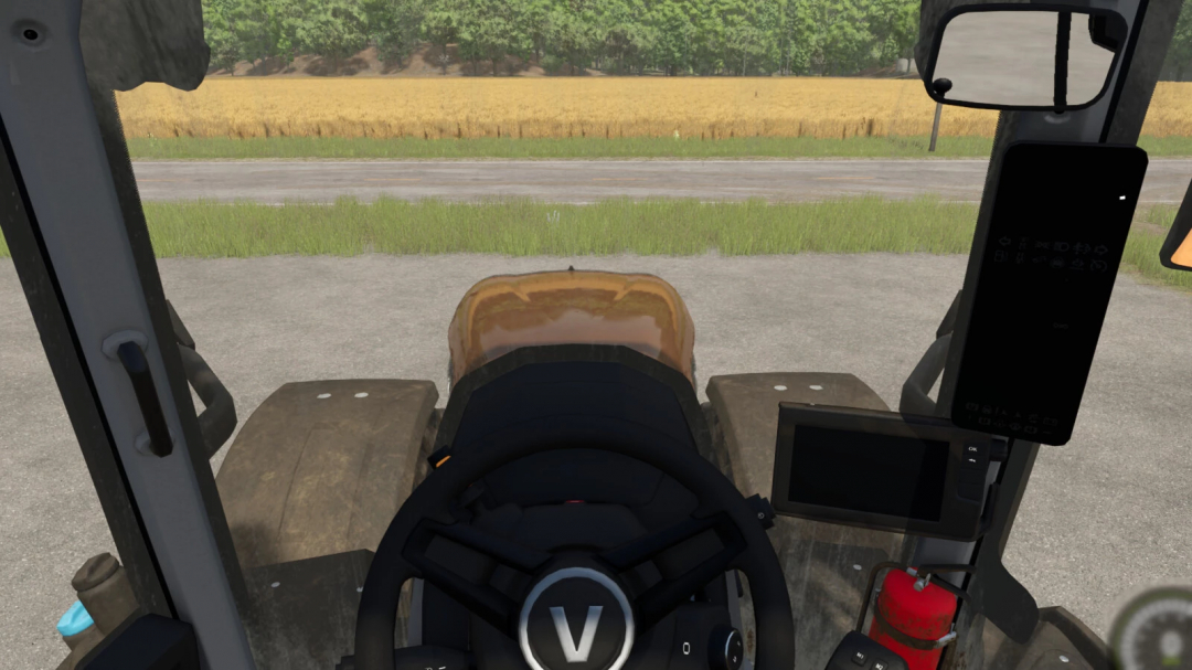 View from inside a tractor cabin in FS25, featuring mods to adjust indoor camera position. Fields and road visible outside.