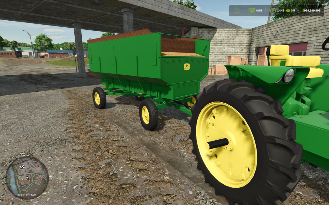 John Deere Barge Wagon in FS25 mod, green wagon hitched to tractor, in a farmyard.