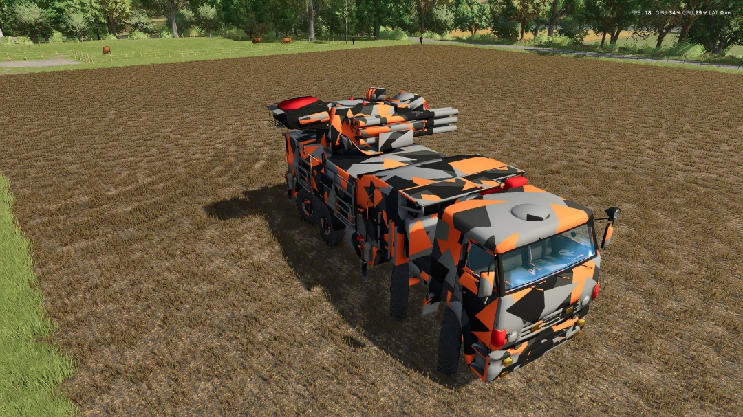 Kamaz 1204 URR mod in Farming Simulator 25 with a vibrant orange and black pattern, displayed on a plowed field.