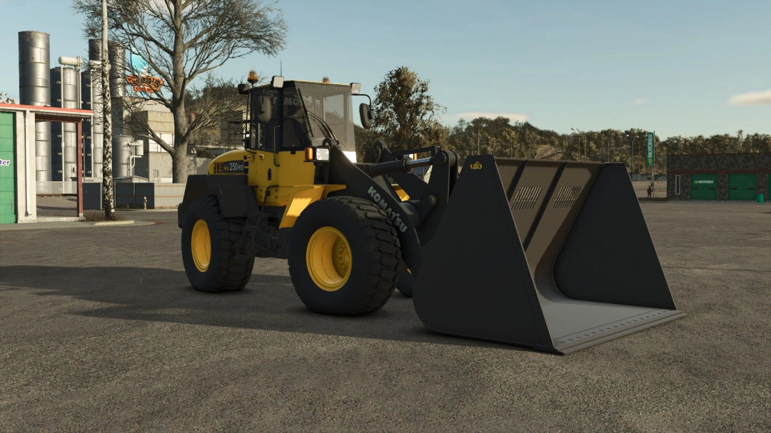 Komatsu 250PZ mod showcased in Farming Simulator 25, featuring a yellow front loader with industrial backdrop, enhancing FS25 gameplay.