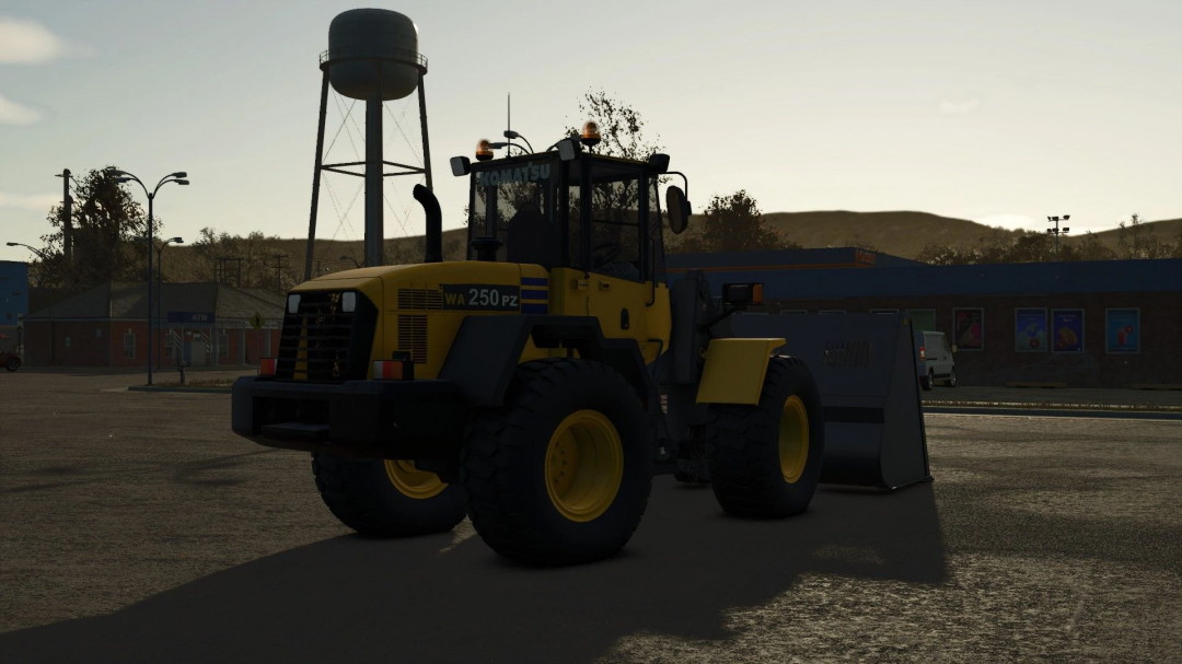 Komatsu 250PZ loader mod in FS25, displayed in a sunset setting with a water tower in the background.