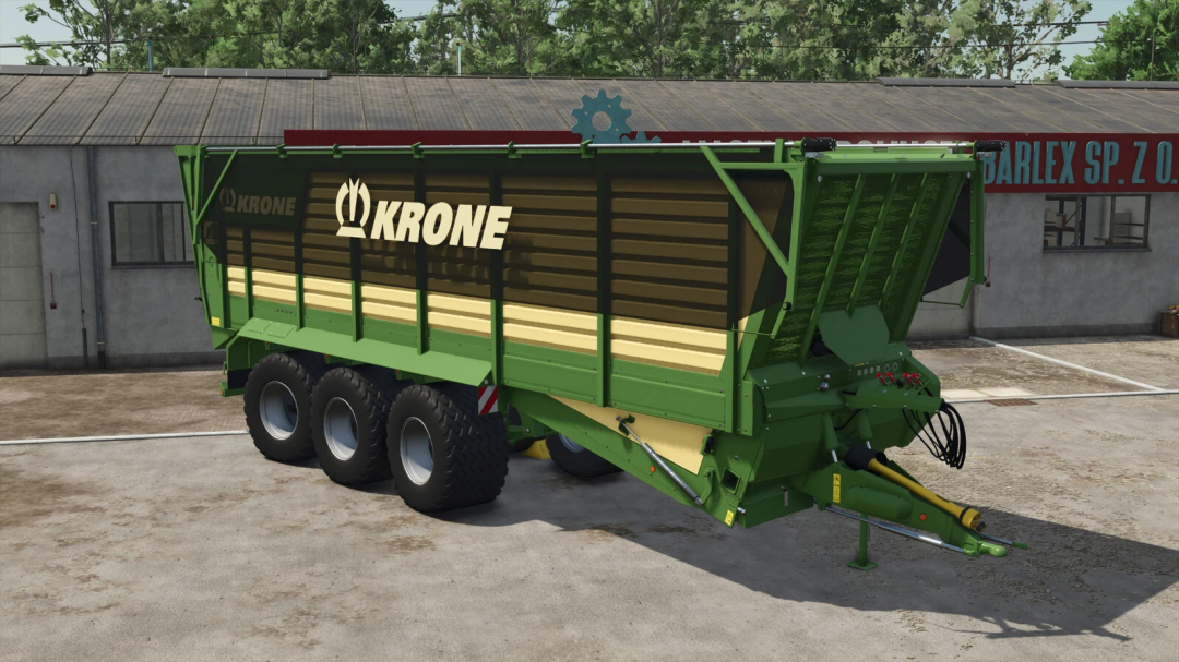 Krone TX 560 D trailer mod in Farming Simulator 25, featuring a green and beige design parked in front of a building.