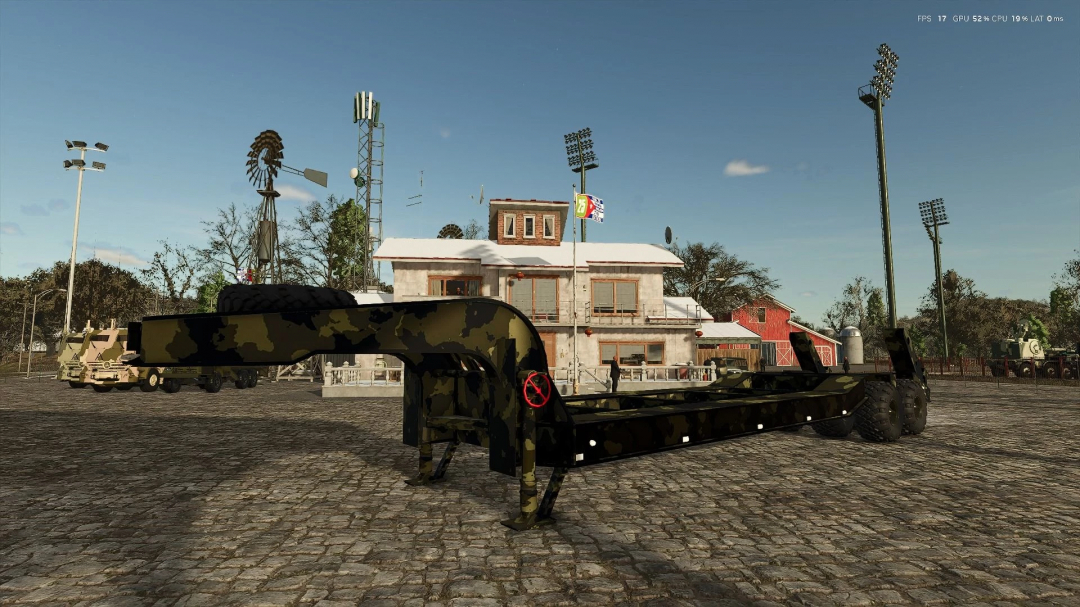 FS25 MAZ MF Pack mod featuring a military-themed trailer in front of a rural building, Farming Simulator 25.