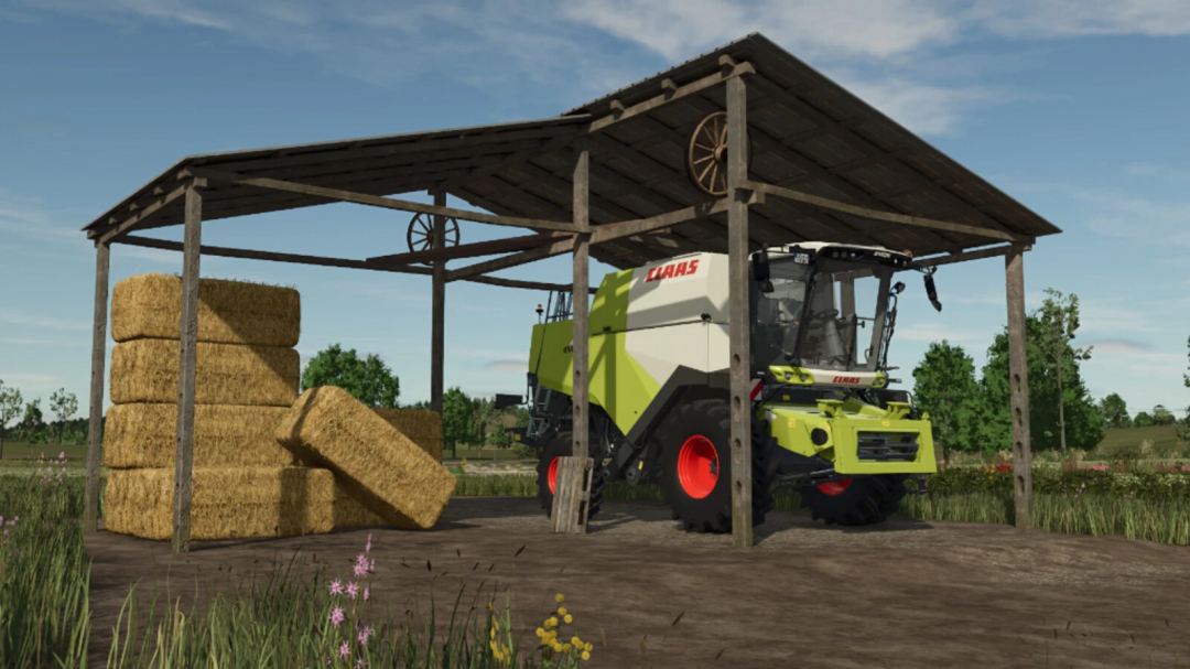 Old farm building set from FS25 mods with hay bales and machinery under a wooden shelter.