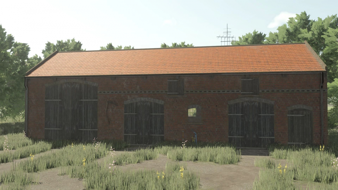 Post German Barn FS25 mod with a brick structure and wooden doors surrounded by grass.