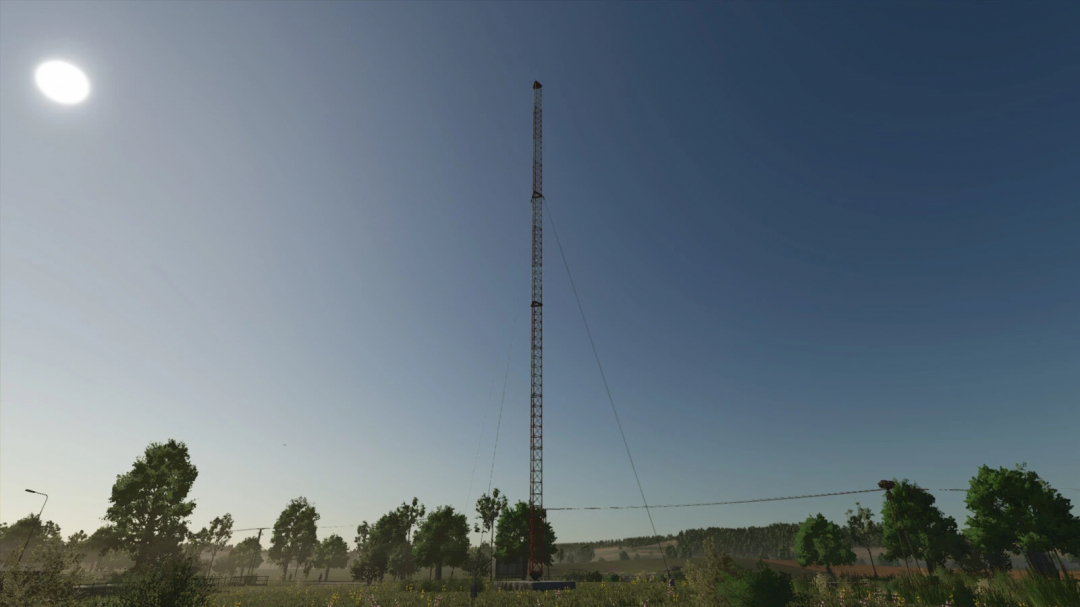 Radio Tower mod in FS25, tall structure against blue sky, surrounded by trees.