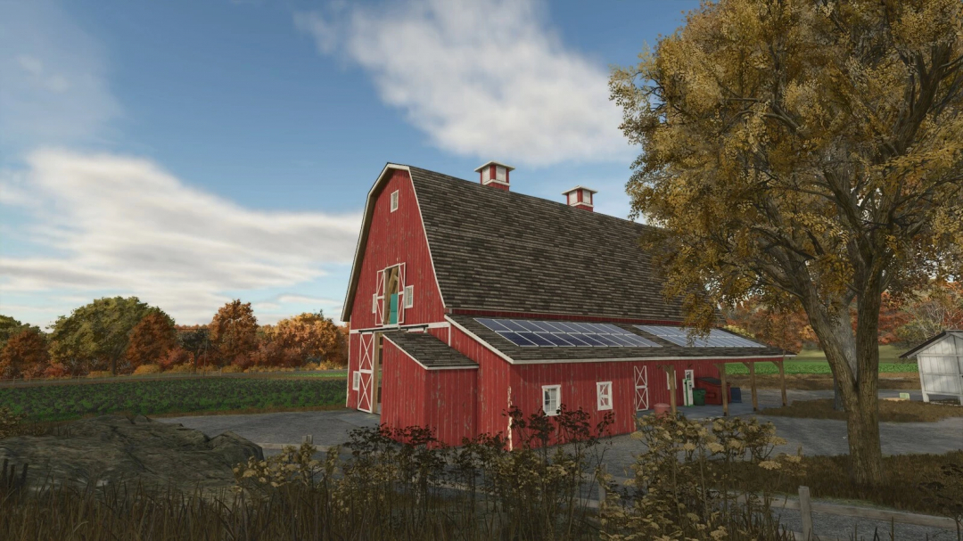 US Farm Barn mod in Farming Simulator 25, featuring a red barn with solar panels, set in a picturesque rural landscape.