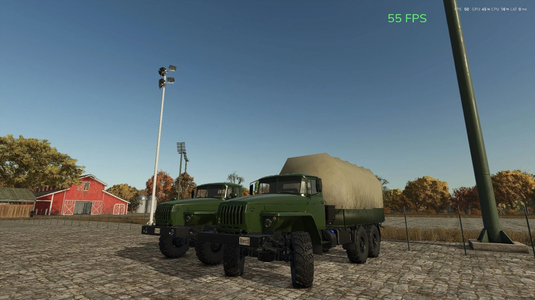 Ural 4320 logistics mod in FS25, featuring two green military trucks parked near a barn.