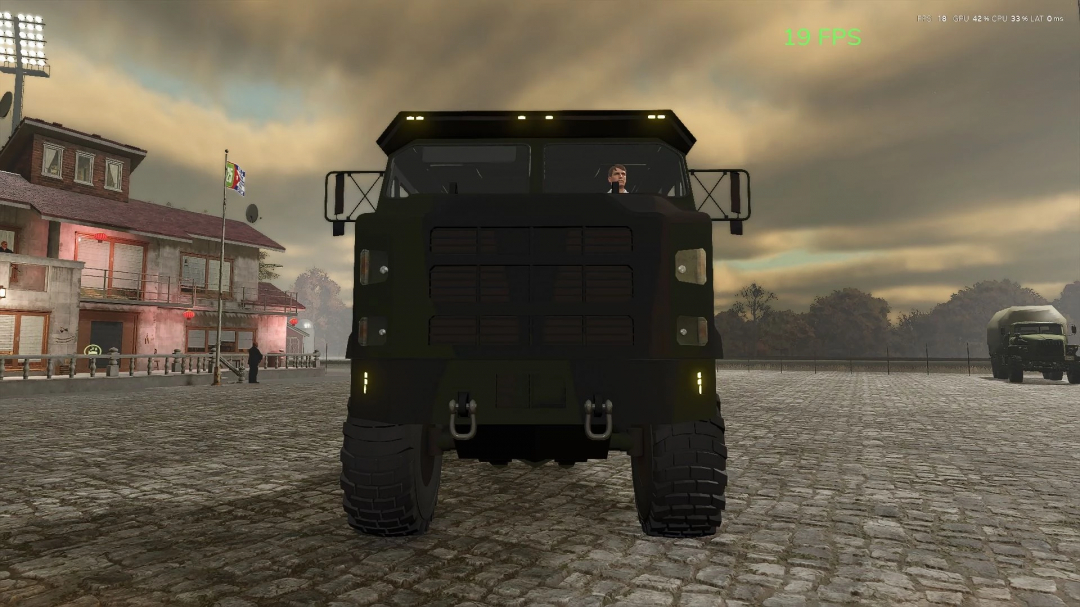 Front view of Ural 4320 v1.0.0.0 mod in FS25, with a truck parked in cobblestone area near buildings.