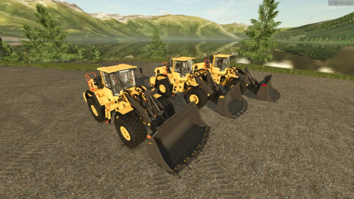 fs25-mods,  Three yellow Volvo 180 rock buckets in FS25 mod, parked on gravel with a scenic mountain backdrop.