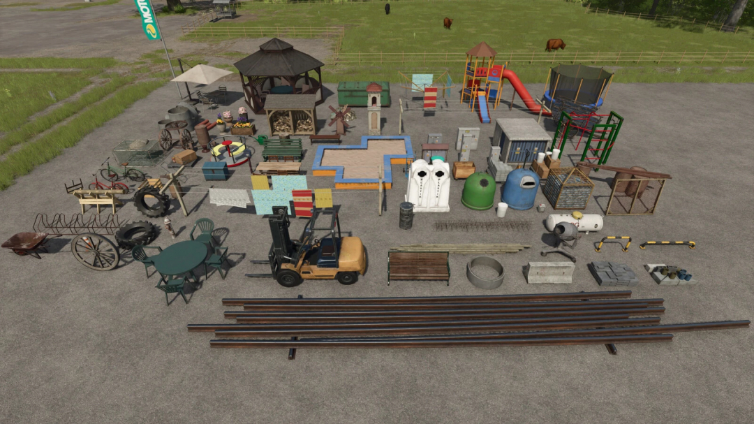 FS25 Big Decoration Package v1.1.0.0 showing various farm and playground items on pavement.