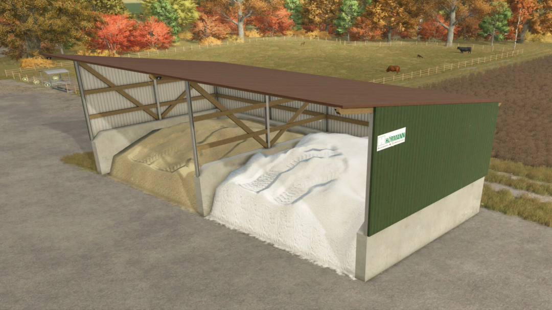 Bulk Material Warehouse mod for Farming Simulator 25 with piles of sand and gravel, surrounded by autumn trees.