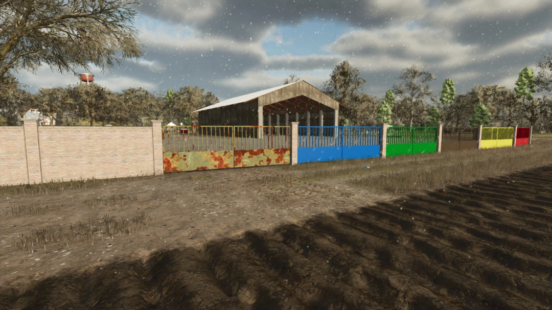 Colorful concrete fences in Farming Simulator 25 mod, version 1.0.0.0, beside a barn under a cloudy sky.