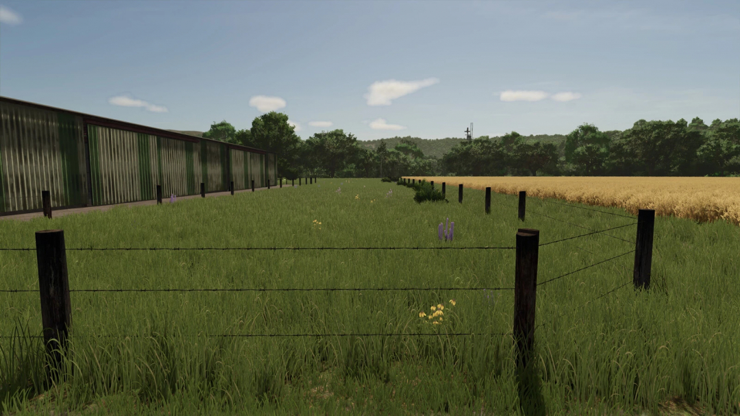 Cow Fences mod in FS25 shows a grassy field with wooden posts and wire fence beside a barn. Ideal for Farming Simulator 25 mods.