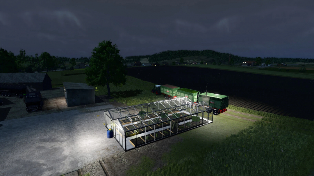 Night view of a Fruit Greenhouse mod in FS25, illuminated with tractor nearby in the field.