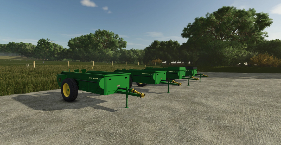 John Deere 34 Manure Spreader mod in FS25 displayed on a concrete surface with trees in the background.