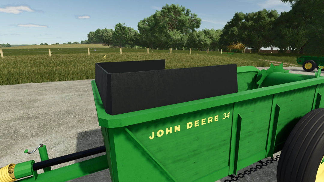 John Deere 34 Manure Spreader in FS25 mod version 1.0.0.0, shown on a farm with lush greenery.