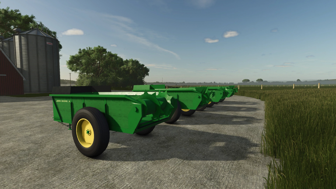 John Deere 34 manure spreaders in FS25 mod version 1.0.0.0 lined up on a farm.