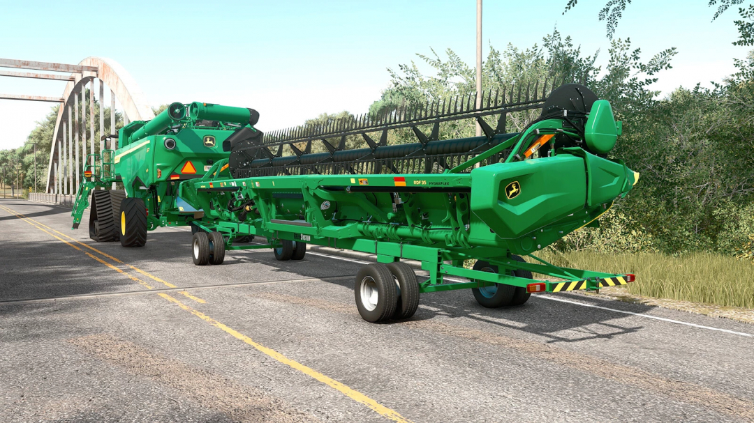 FS25 mod John Deere GreenSystem Trailer Pack v1.0.0.0 on a road with a bridge in Farming Simulator 25.