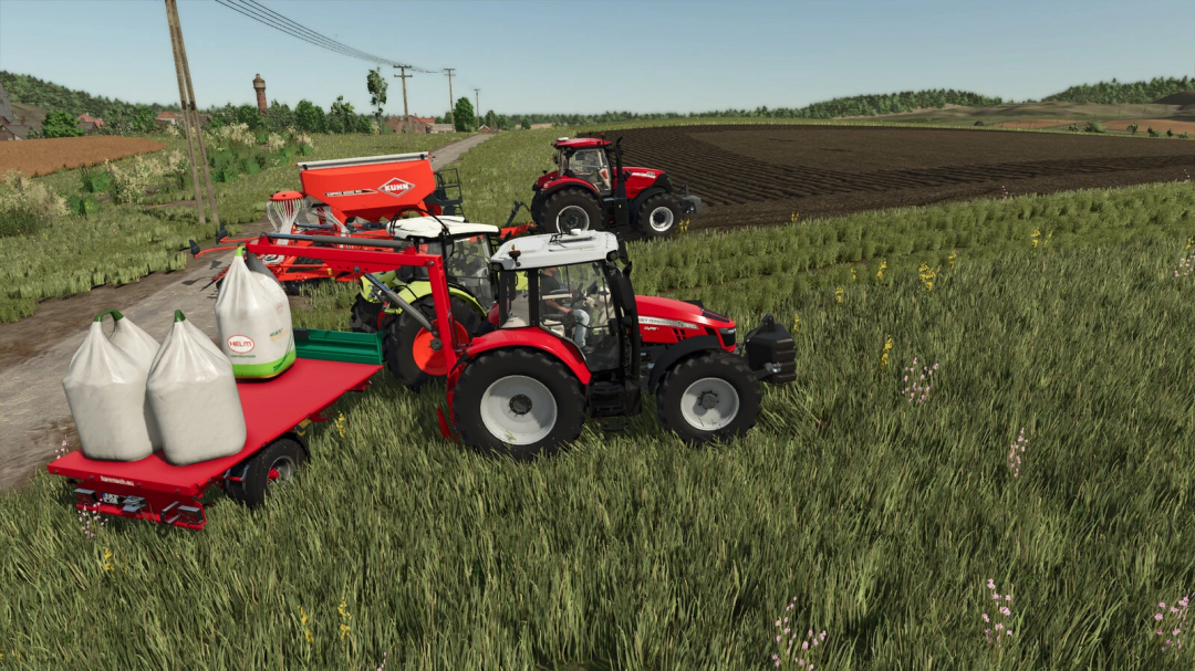 Tractor using Lizard Bigbaglift mod in FS25 with big bags on a field.