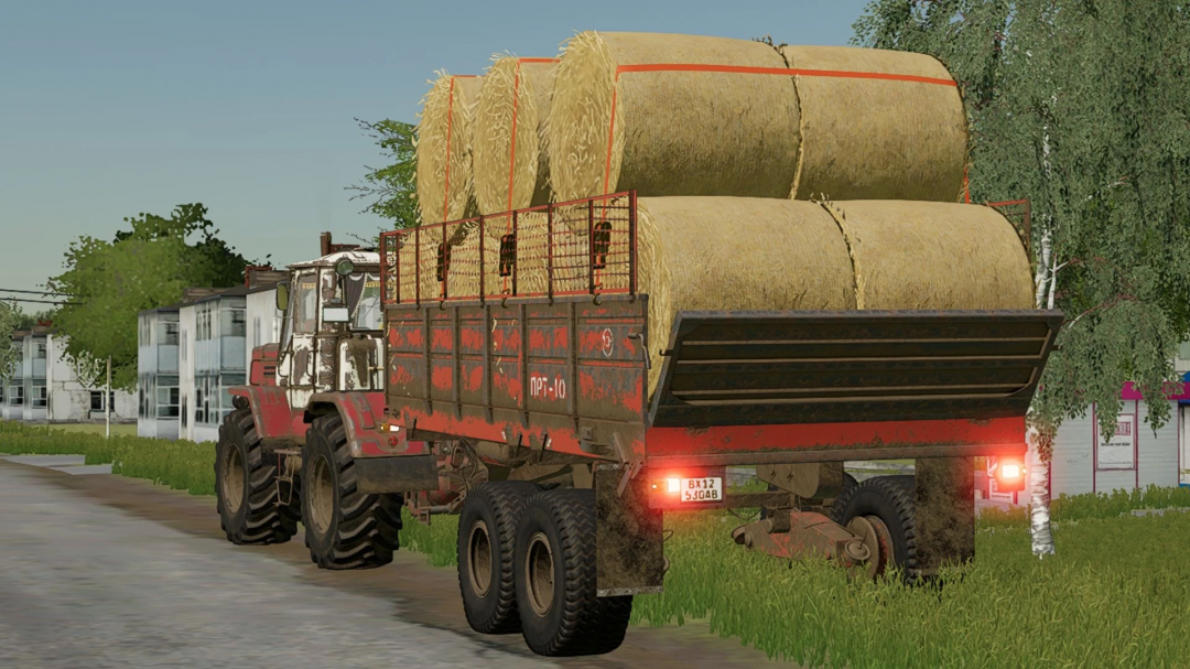 PRT-10 trailer carrying hay bales attached to a tractor in FS22 mod.