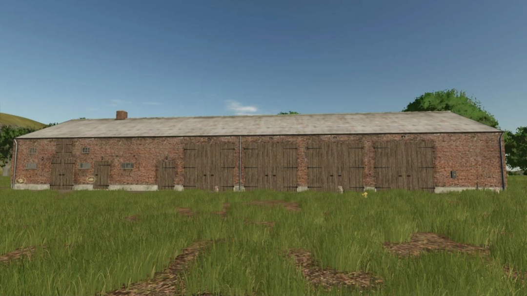 FS25 mod showing an old brick building in a grassy field under a clear sky.