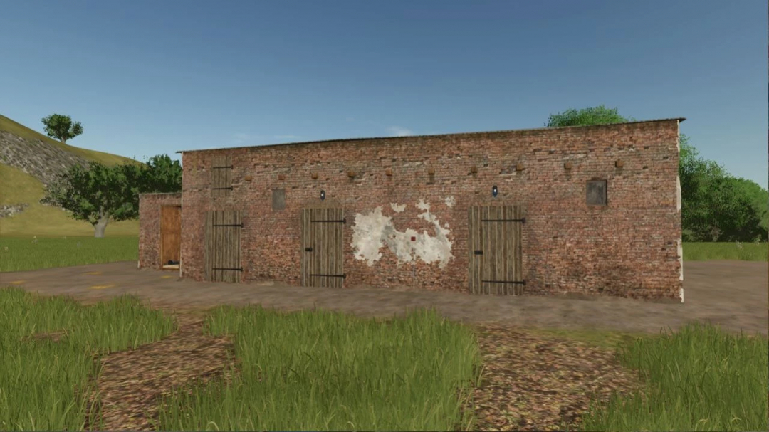 Old brick building mod in FS25, showcasing rustic design with wooden doors and aged walls.