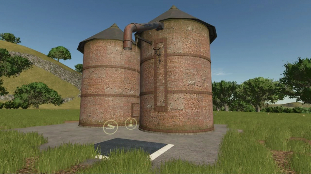 FS25 mod of a pack of old brick buildings featuring two cylindrical silos in a grassy landscape.