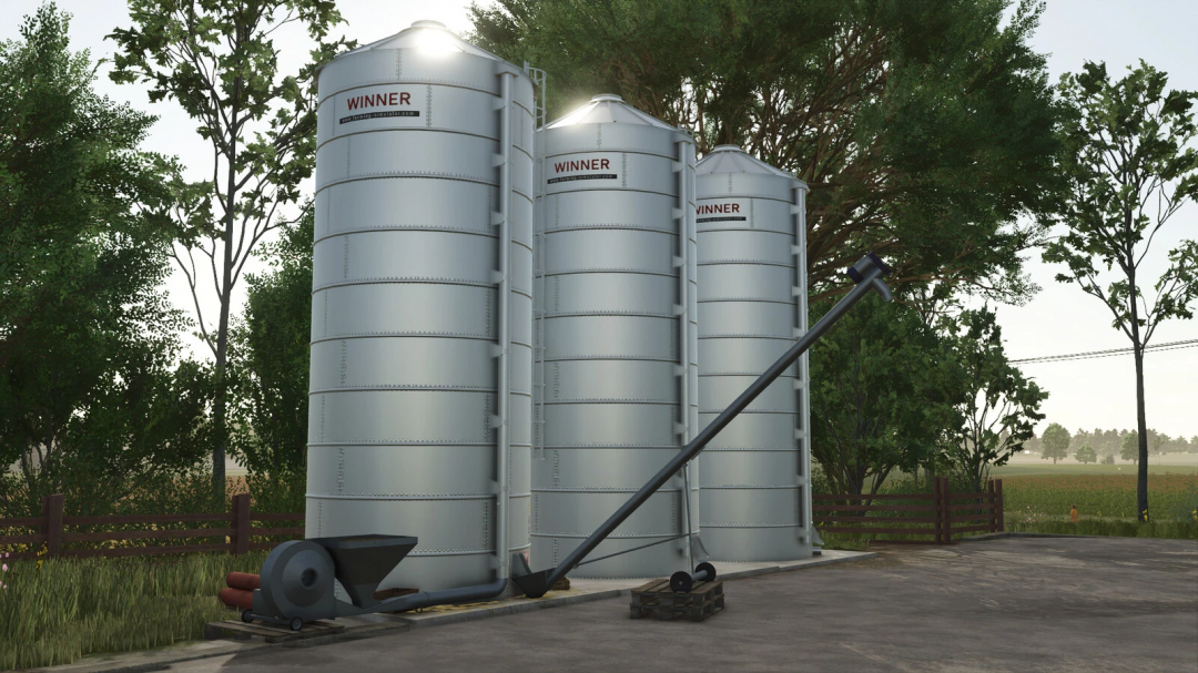 Three silver silos labeled 'WINNER' in FS25 mod Small New Silos v1.0.0.0, surrounded by trees and open field.