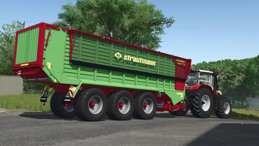 Strautmann Magnon 530 mod in FS25, showing a tractor pulling the large green and red trailer on a sunny day.