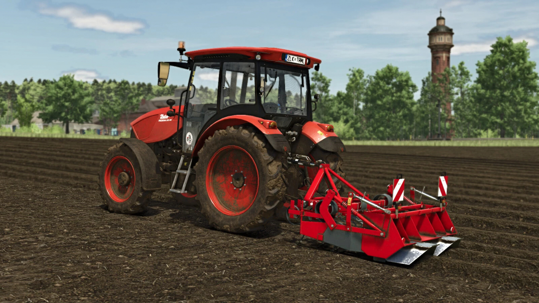 A red tractor with the Unia Forma 2 mod in FS25, cultivating a field.