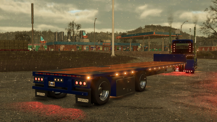 fs25-mods,  EXP25 Kalyn Siebert Dropdeck Trailer mod in FS25, parked near a gas station under cloudy skies.