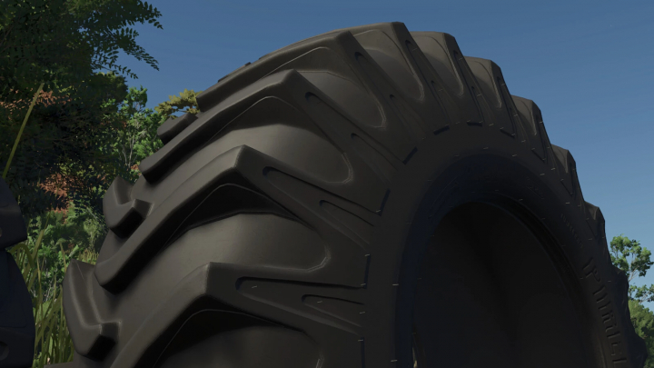 fs25-mods,  Close-up of Pirelli-Lizard MB39 tire from FS25 mod against a blue sky.