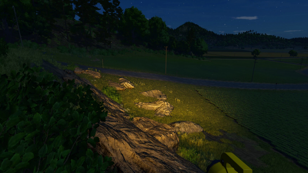 Night scene in Farming Simulator 25 with Big Flashlight mod illuminating a rocky field.