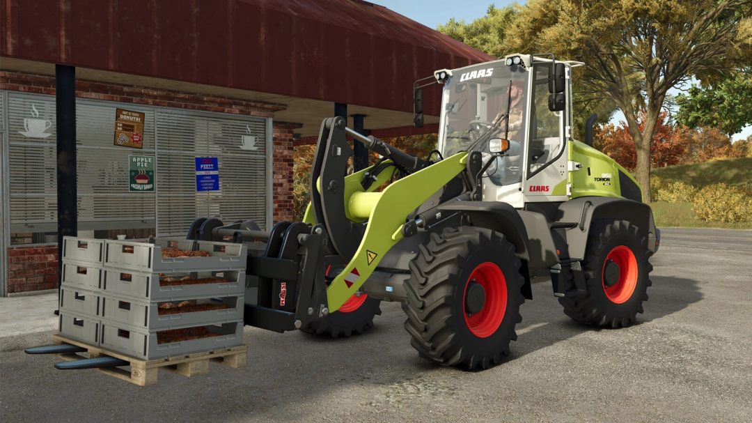 FS25 mod CLAAS TORION 956 SINUS loading crates outside a building