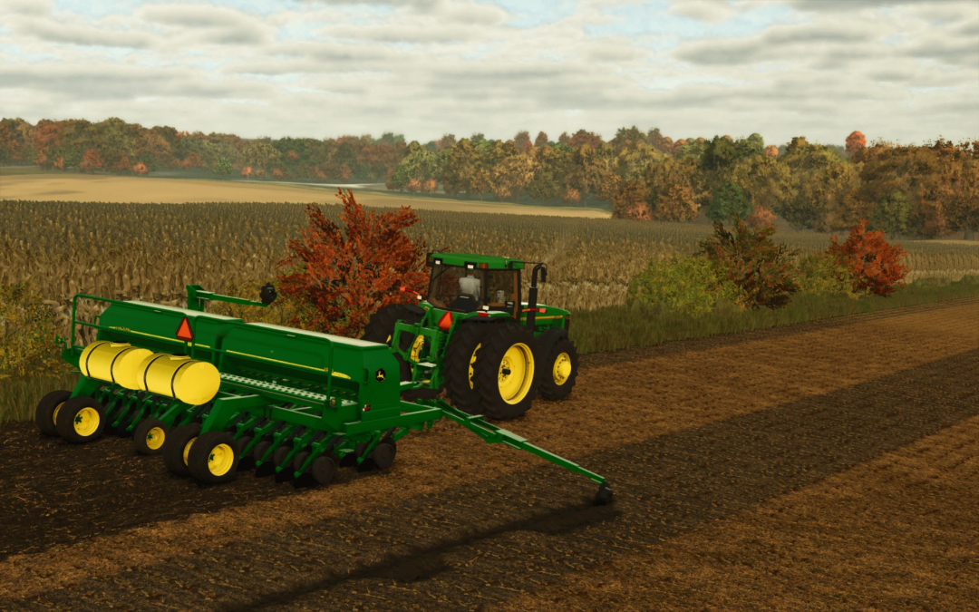 FS25 John Deere 1590 Drill mod in action on a field in Farming Simulator 25, showcasing autumn foliage.