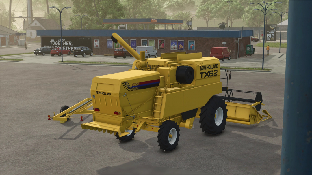 FS25 New Holland TX62 mod in Farming Simulator 25, showcasing a yellow combine harvester in a parking area.