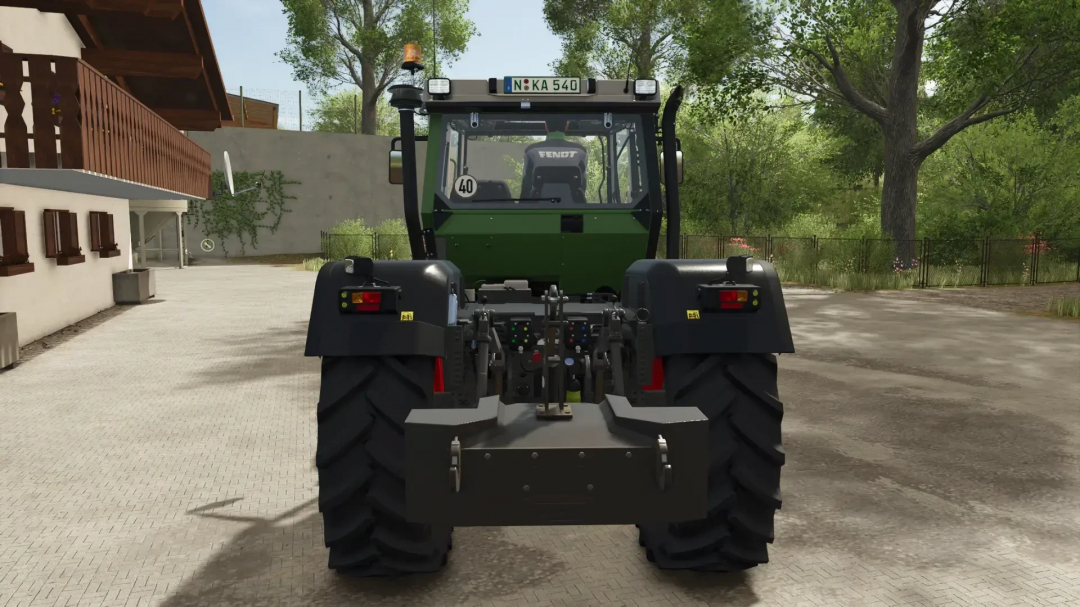 Rear view of a Fendt tractor from the Implement Carrier Pack mod in FS25, parked near a house in Farming Simulator 25.