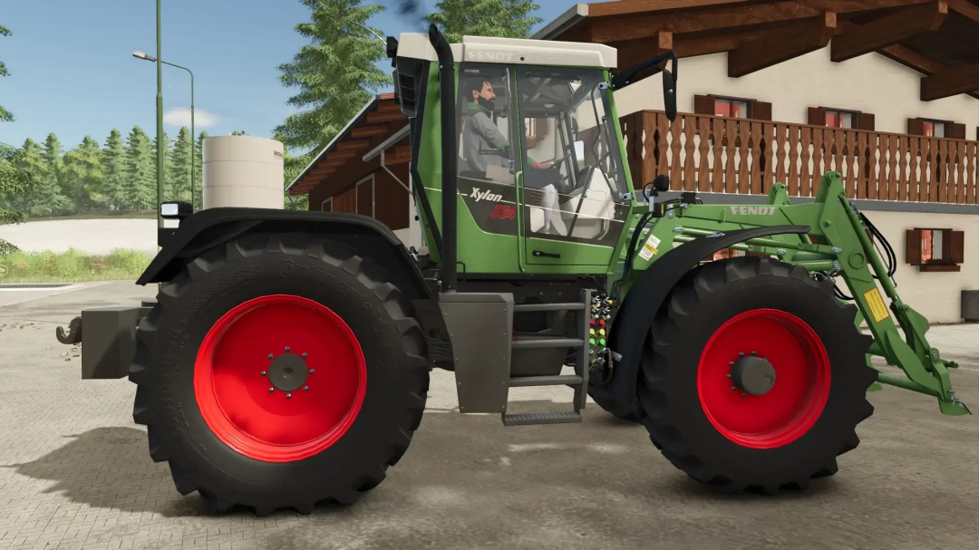 Fendt Implement Carrier mod in FS25 with green body and red wheels next to a wooden house.