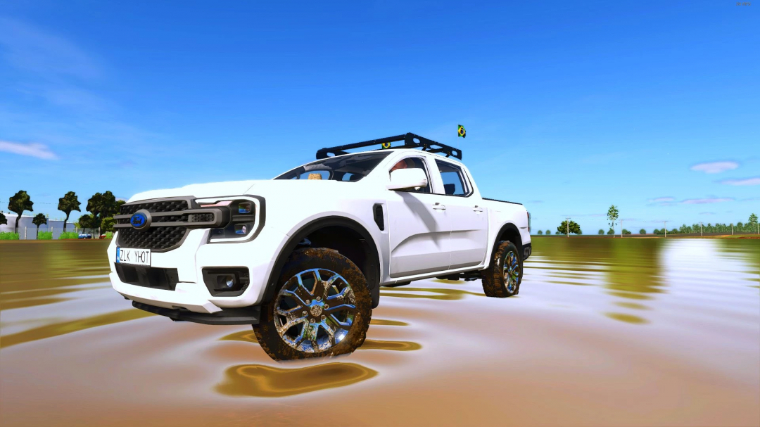 Ford Ranger 2025 Limited Edition mod in FS25 driving through muddy terrain under blue sky.