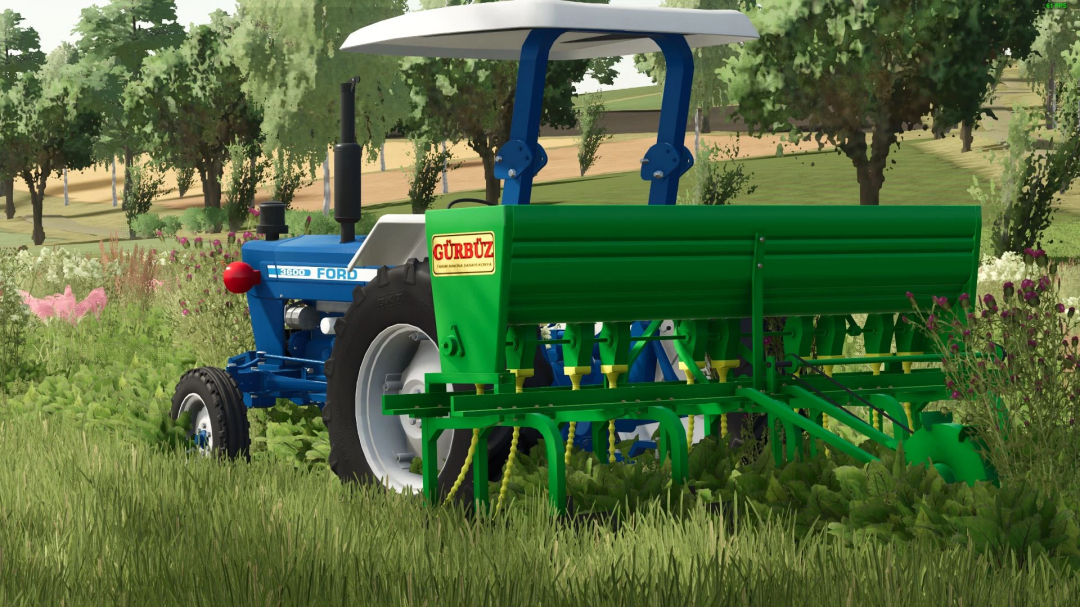 Gürbüz Mister v1.0.0.0 mod with a Ford tractor in FS25, showcasing a green implement on a lush farm landscape.