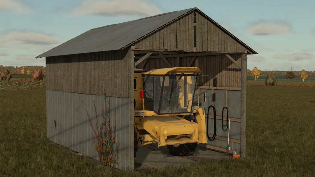 Harvester stored in a wooden shed in FS25 mod Harvester Shed v1.0.0.0, set in a grassy field.