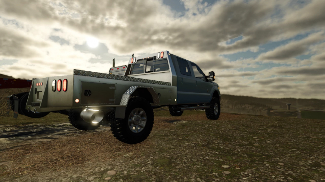 FS25 mod 2015 Ford F350 v1.1.0.0 shown in a rural setting, highlighting its robust design.