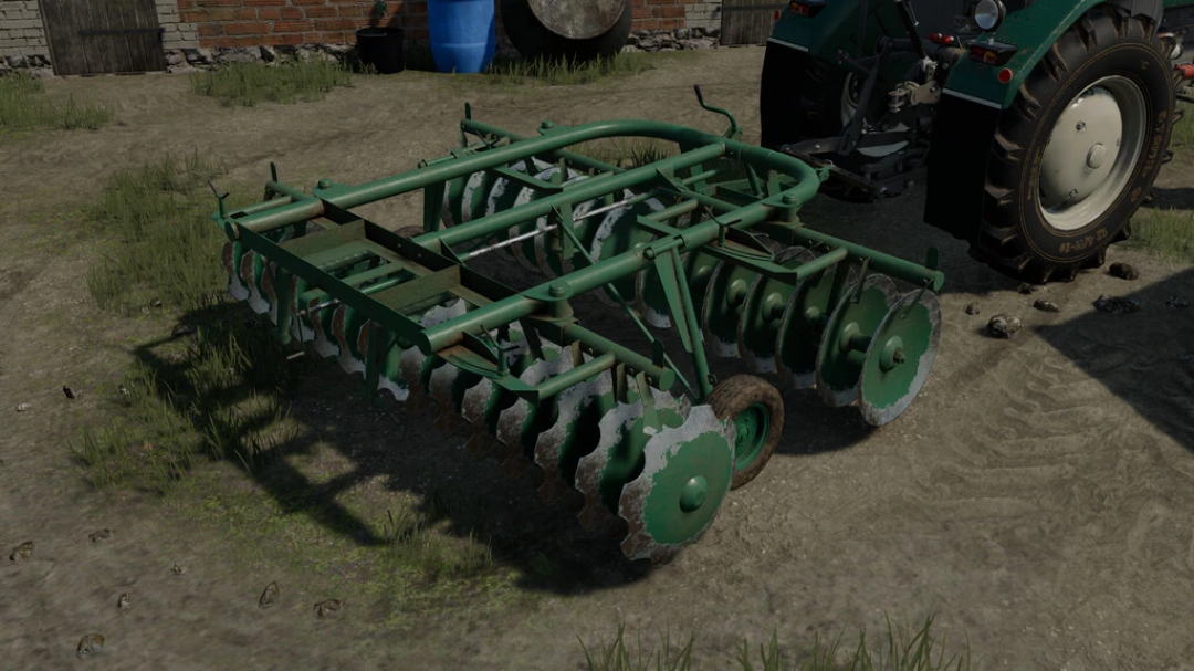 BTc 2,5 / U202/0 Sawa mod in FS22 showing a green disc harrow near a tractor, enhancing Farming Simulator 22 experience.