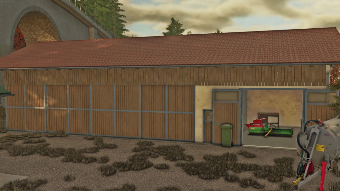 Bavarian Barns mod in FS25, showcasing a large wooden barn with a red roof and farming equipment inside.