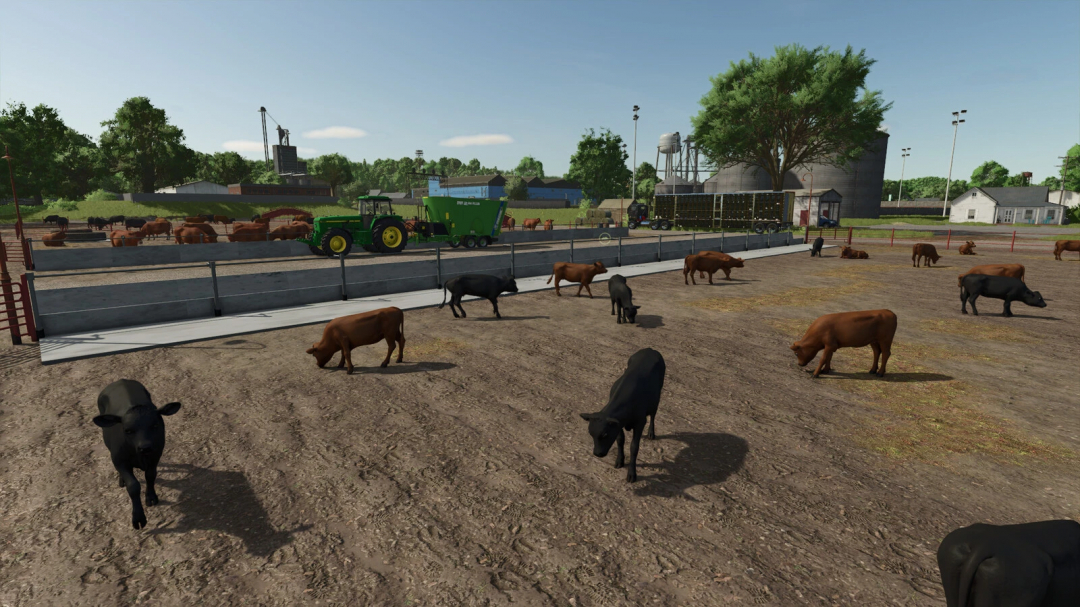 Buildable Feedlot Pack mod in FS25 showing cattle grazing in a large fenced area with farm equipment nearby.