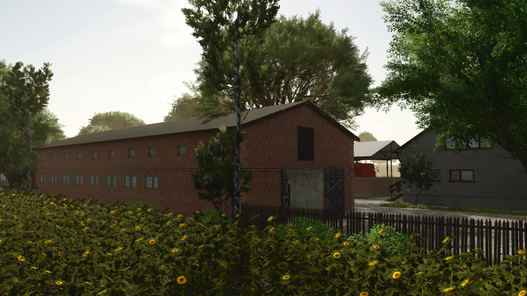 A brick barn among sunflower fields in FS25 Buildings Package mod.